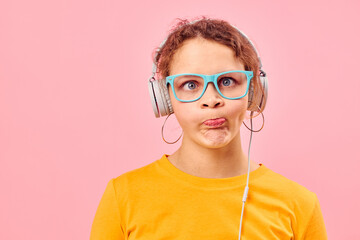 funny girl yellow t-shirt headphones entertainment music fun pink background unaltered