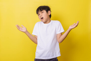 Casual-style little boy shrugging, confused and clueless expression with arms and hands raised. Doubt concept.