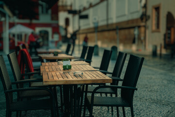 Tables and chairs of a street restaurant in old Prague