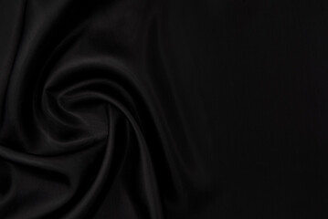 Part of the dark fabric texture of the fabric for the background and decoration of the work of art, a beautiful crumpled pattern of silk or linen. A crumpled piece of cloth