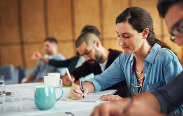 The creative process. Shot of a group of colleagues working together at a table in an office.