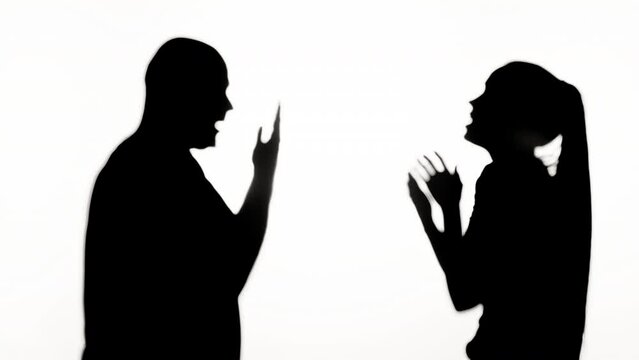 Man and woman quarrelling on white background. Shadows silhouette of couple having quarrel, family problems, conflicts in relationships.