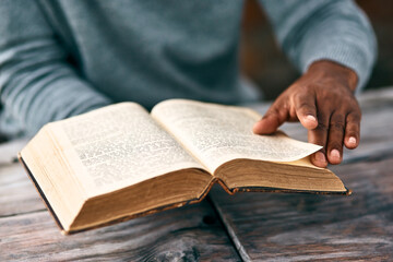 I just have to go back to the previous page. Cropped shot of an unrecognizable man reading a book.