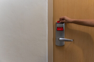 Naklejka premium Hand of woman is opening door of room in hotel, apartment, condo by proximity card, Digital or keyless to authenticate. Technology for security.