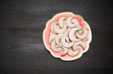 Traditional German or Austrian Vanillekipferl vanilla kipferl cookies on decorated ceramic plate