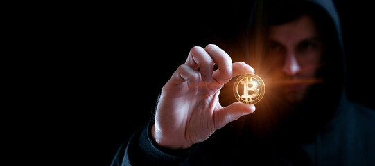 Crypto money bitcoin background. Crypto hacker hand hold golden BTC bit coin. Digital money, stock market concept.