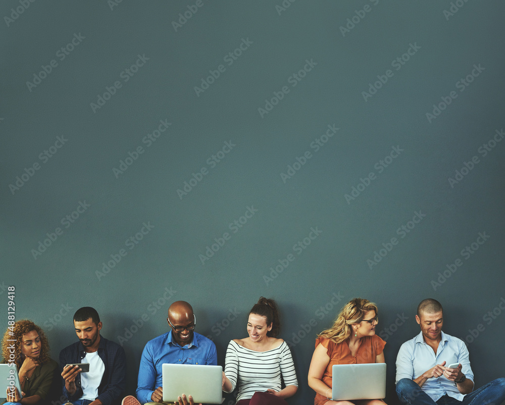Aufkleber Connecting while we are connected. Studio shot of a diverse group of people social networking against a gray background.