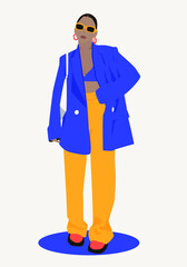 style fashionable girl in glasses and a blue jacket, yellow pants and trendy glasses