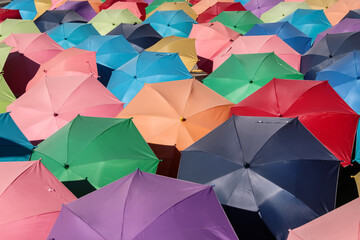 Many colorful multicolor open umbrella on floor outdoor background - obrazy, fototapety, plakaty