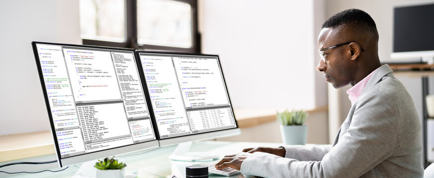 Computer Programmer Writing Program Code On Computer