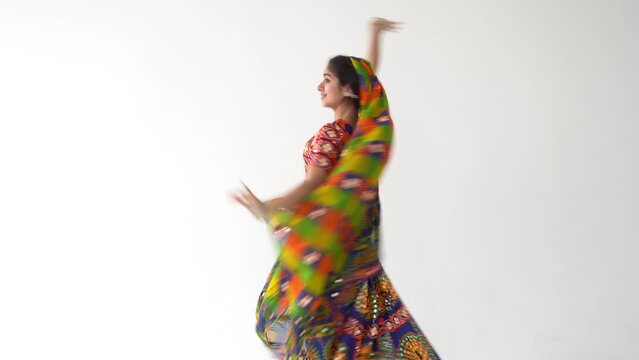 Beautiful indian woman dancing dance wearing ethnic indian dress. Welcome to India concept. Indian culture.