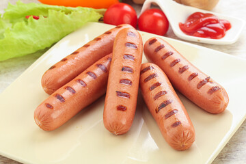 Grilled sausages with tomato sauce