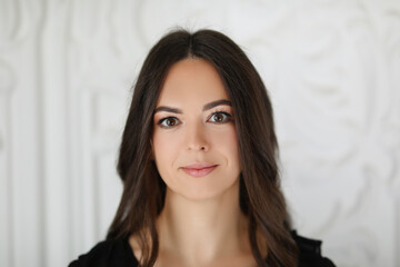 Fototapeta premium Portrait a beautiful brunette woman with long hair