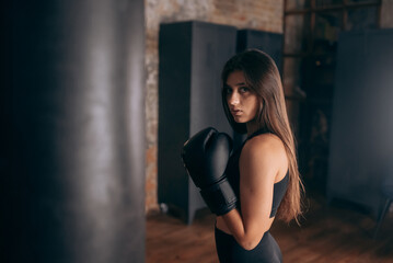 Fototapeta na wymiar Young woman boxing workout at the gym