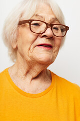 Photo of retired old lady in casual t-shirt and glasses isolated background