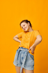 funny girl in a yellow t-shirt posing emotions isolated backgrounds unaltered