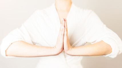 mental health, positive aura,woman holding hands in yoga practice namaste mudra gesture. close-up....