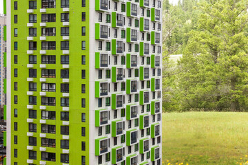 City modern apartment green real estate mixed use building with eco green forest background. Beautiful view housing sustainable development