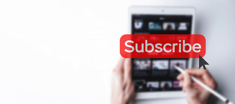 Subscribe banner. Online video subscription red button. Internet service on laptop digital tablet blured technology background. Social media concept. Streaming video.
