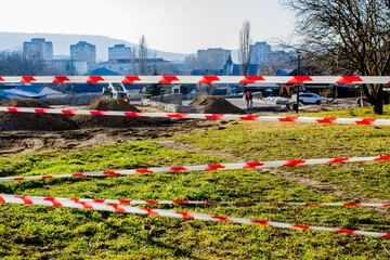 The red and white lines of the barrier tape prohibit passage. Barrier to prevent movement. Hazard...
