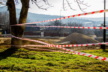 The red and white lines of the barrier tape prohibit passage. Barrier to prevent movement. Hazard warning tape not included. The concept of no entry. stop tape
