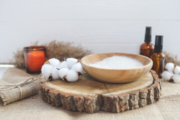 Organic spa beauty products and natural skin care concept. Set of natural oils, facial scrub, brush, candle and cotton on a wooden background