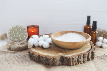 Organic spa beauty products and natural skin care concept. Set of natural oils, facial scrub, brush, candle and cotton on a wooden background