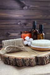Obraz na płótnie Canvas Natural handmade soap and massage brush with oils on a wooden background. SPA relax concept