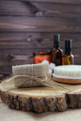 Natural handmade soap and massage brush with oils on a wooden background. SPA relax concept