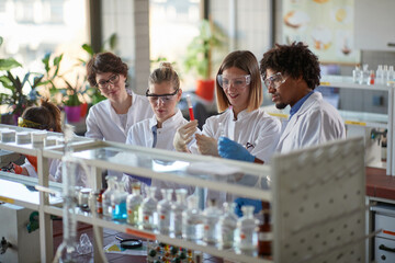 Young students enjoy working with chemicals in a laboratory. Science, chemistry, lab, people