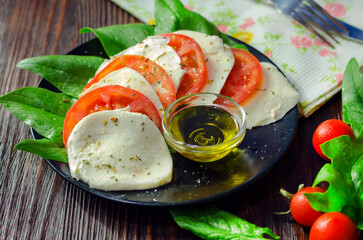 Salad of mozzarella, fresh tomatoes, spinach and basil.