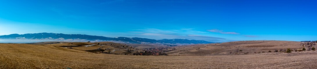 Panoramic view from the top of the hill in Transylvania, Romania, small hungarian village in the valley.