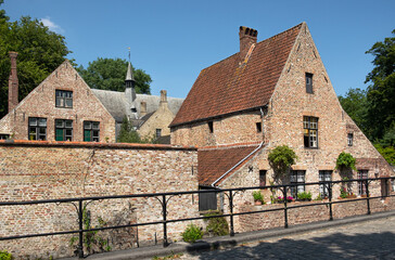 Fototapeta na wymiar Medieval houses nearby the Princely Beguinage Ten Wijngaerde in the old part of Bruges, Belgium, Europe
