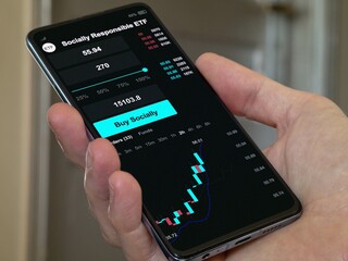 Stock world exchange market etf chart, stock market data on smartphone. Business analysis of a trend exchange-traded fund. Invest in international socially responsible fund