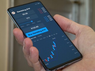 Exchange-Traded Fund chart, Stock market data on smartphone. Business analysis of a trend. Invest in international gambling ETF