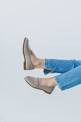 Woman's legs in trousers and beige leather shoes