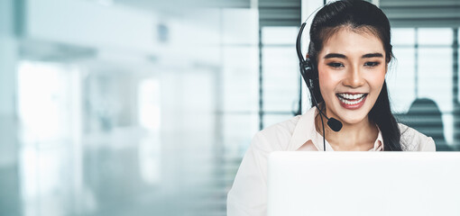 Businesswoman wearing headset working actively in office . Call center, telemarketing, customer support agent provide service on telephone video conference call.