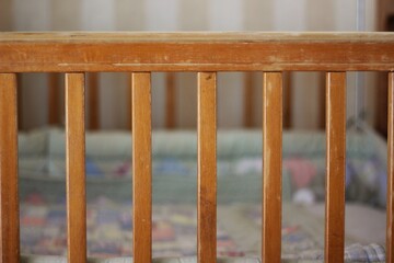 Obraz na płótnie Canvas Closeup of the wooden slats of a baby crib.