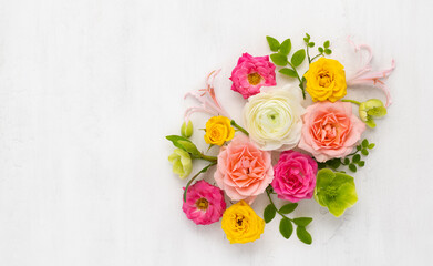 Roses Arrangement. Composition of colorful Roses Flowers and green leaves on light background. Top...
