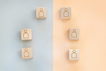 wooden cubes with the image of people stand at a distance from each other.