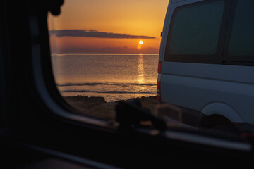 Enjoying a beautiful sunrise by the sea, with caravans and friends.
