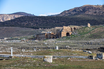 Amphitheater in ancient city of the Hierapolis. Dramatic sunset sky. Unesco Cultural Heritage Monument. Pamukkale, Turkey