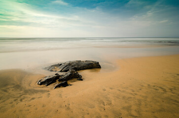 black rocks at atlantic sea and sand