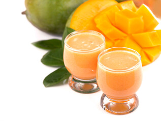 juicy, fresh exotic fruit mango and glasses of juice on a white background