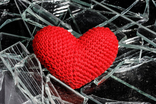 red heart on broken glass. unhappy love concept