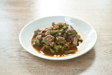 spicy stir-fried slice yard long bean and chicken gizzard couple liver with chili curry sauce on plate