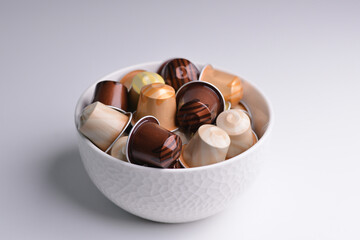 Bowl of Coffee Capsules for a Coffee Machine on a white Table Background Copy Space