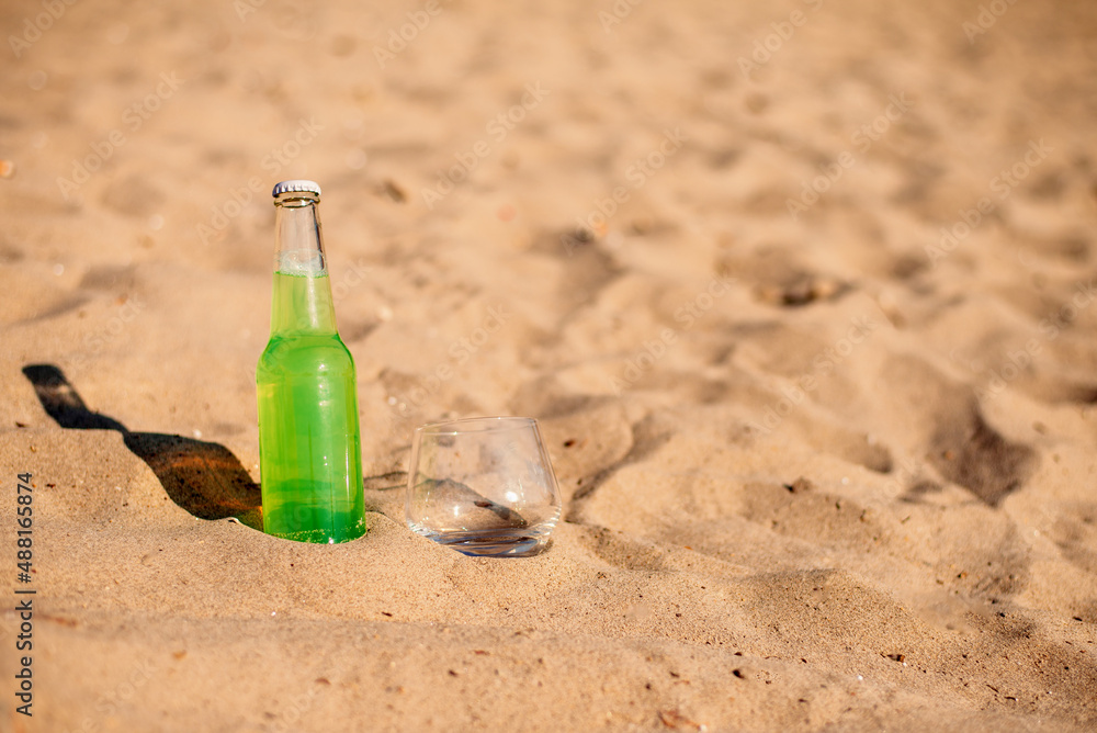 Wall mural bottle on the beach.