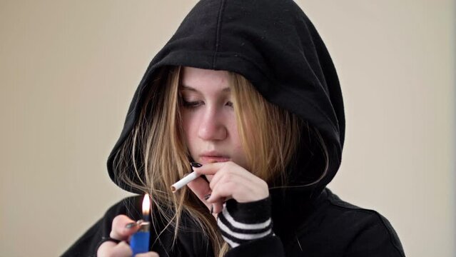 Teenage girl wants to smoke, but doubts. Problems of adolescence.
