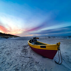 Colorful fishing boat on the beach at sunset, Dębki, Poland
